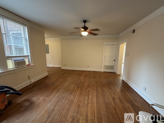 A room with wooden flooring and a ceiling fan.