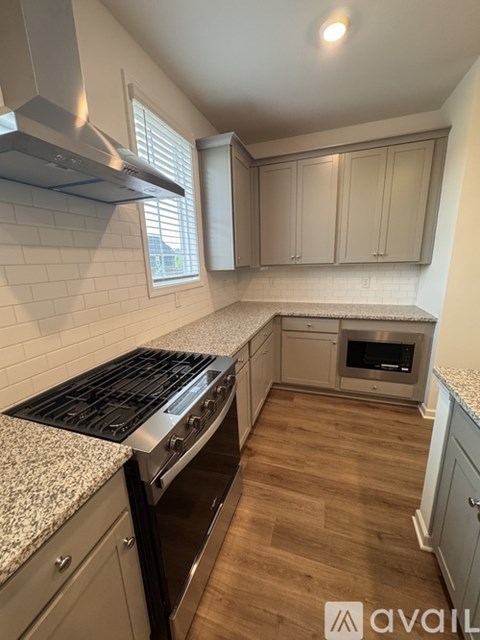 A kitchen with a stove top oven and a microwave.