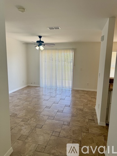 A room with a tiled floor and a ceiling fan.