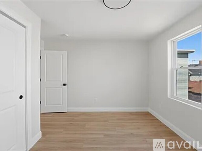 A room with a white door and a window with blinds.
