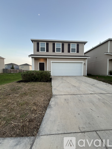 A two-story house with a garage is shown in the image.