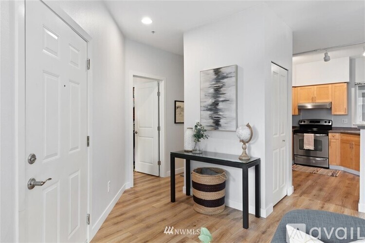 A modern kitchen with a dining table and chairs in the middle of the room.
