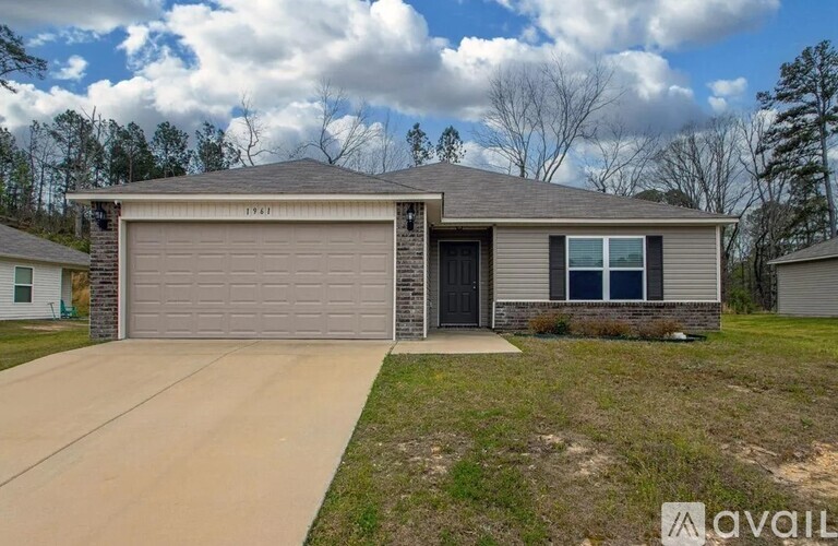 A house with a grey garage door is for sale.
