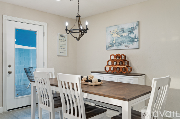A dining room with a table and chairs.