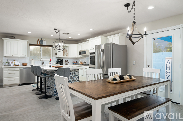 A modern kitchen with white cabinets and a wooden island.