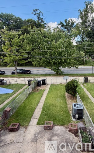A backyard with a pool and a fence.
