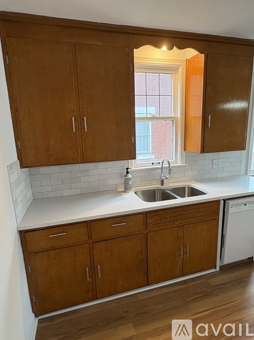 A kitchen with wooden cabinets and a white countertop.