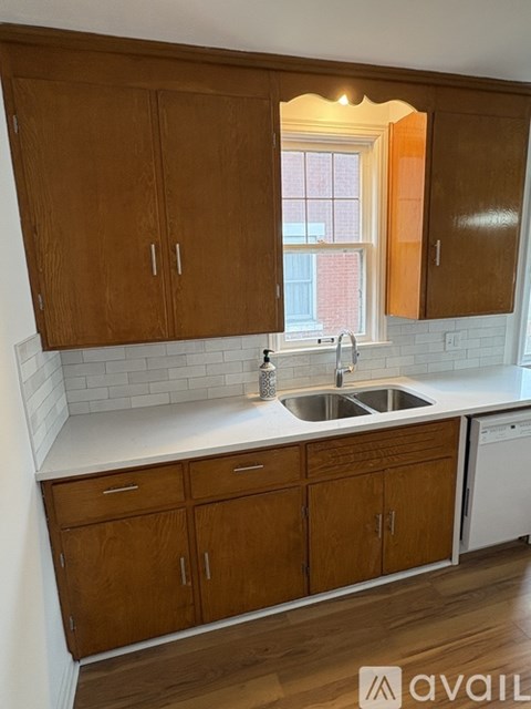 A kitchen with wooden cabinets and a white countertop.