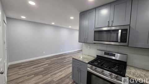 A kitchen with a stove and microwave oven.