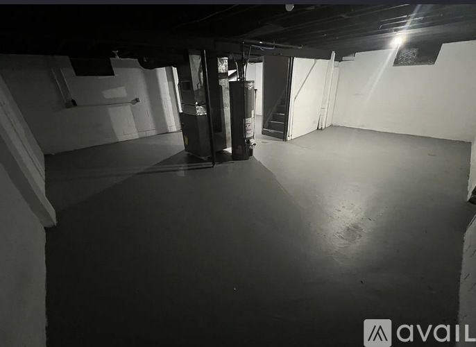 A black and white image of an empty room with a door in the center.