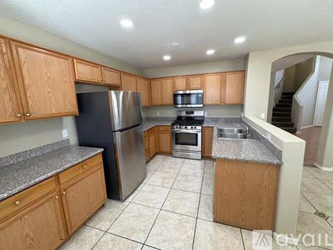 A kitchen with wooden cabinets and stainless steel appliances.