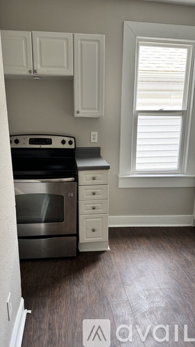 A kitchen with a stove top oven and a microwave.