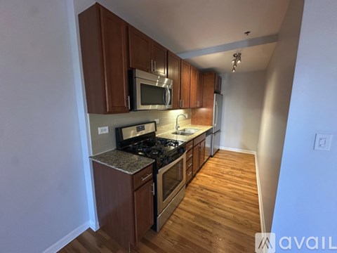 A kitchen with wooden cabinets and a granite countertop.