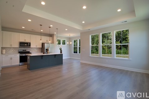 A spacious kitchen with wooden floors and a large island.