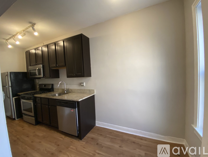 A kitchen with wooden cabinets and stainless steel appliances.