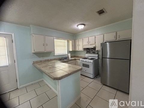 A kitchen with a stove, oven, and refrigerator.