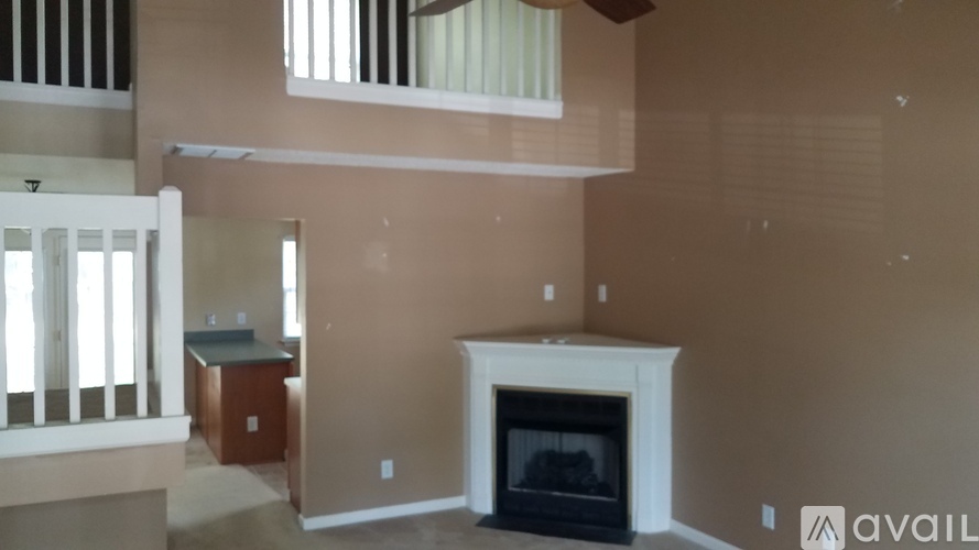 A living room with a fireplace and a cabinet.