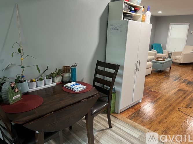 A dining room with a wooden table and chairs.