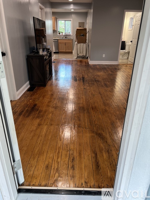 A room with wooden flooring and a white door.