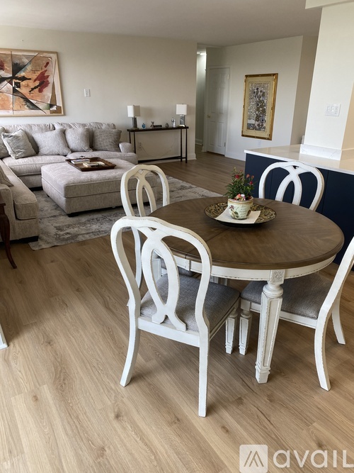 A dining room with a round table and chairs.