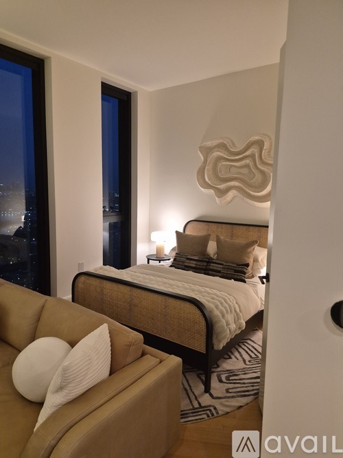 A bedroom with a large bed and a couch.
