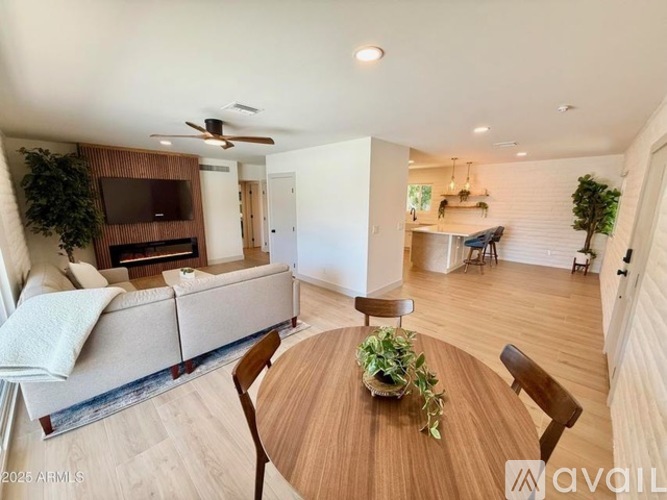 A living room with a couch, a table, and a television.