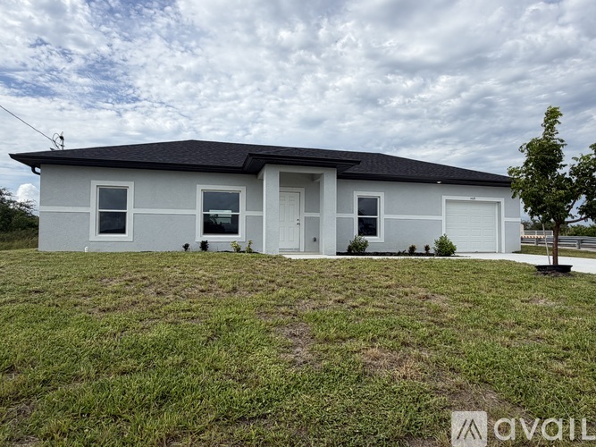 A two-story house with a grey roof and white walls.