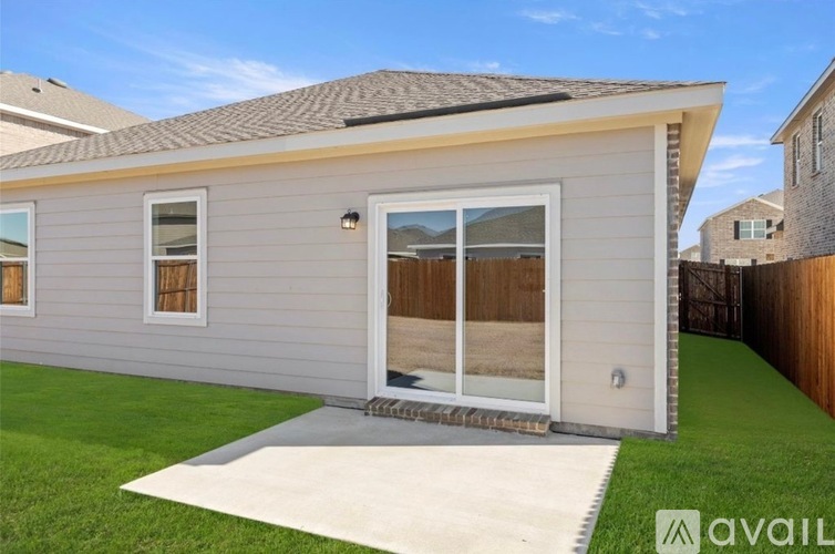 A house with a grey exterior and a white door is available for sale.