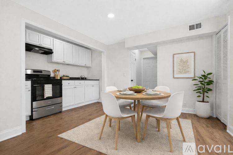 A kitchen with a dining table set for four.