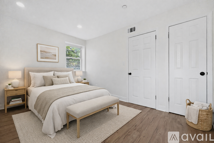 A bedroom with a large bed and two doors.