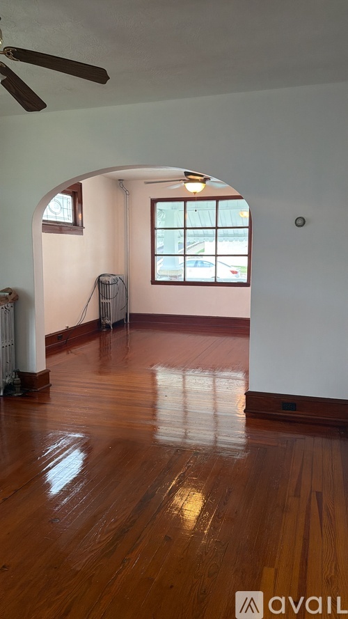 A room with a fan and a window.