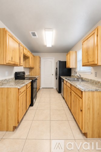 A kitchen with wooden cabinets and black appliances.
