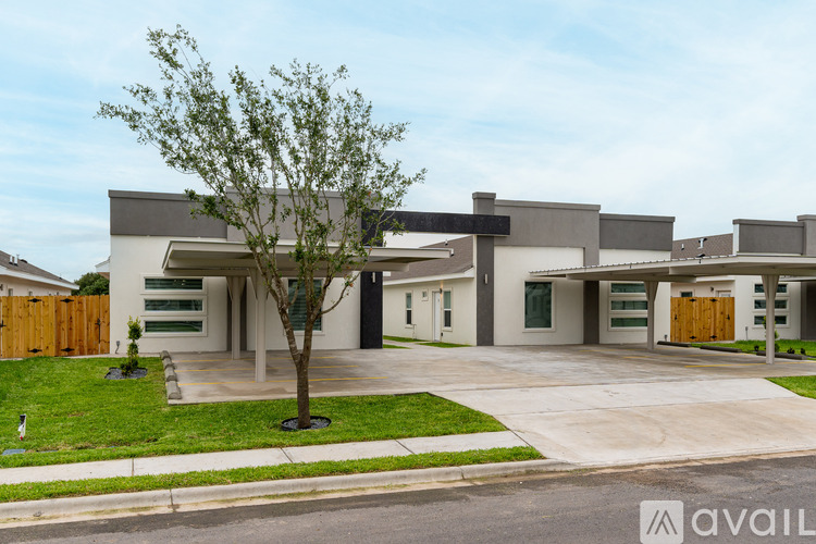 A modern house with a tree in front.