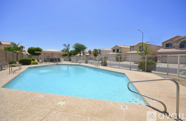 A small pool in a fenced in area.