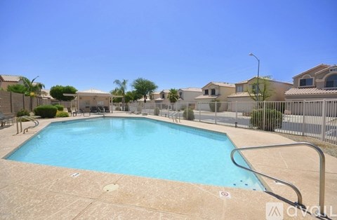 A small pool in a fenced in area.
