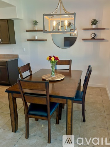A dining room with a wooden table and chairs.
