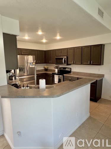 A kitchen with a white island in the middle.