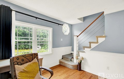 A living room with a chair and a window.