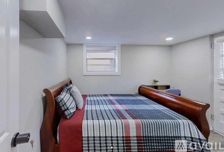 A bedroom with a bed and a window.