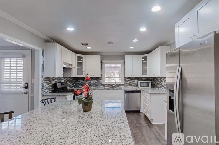 A kitchen with granite countertops and stainless steel appliances.