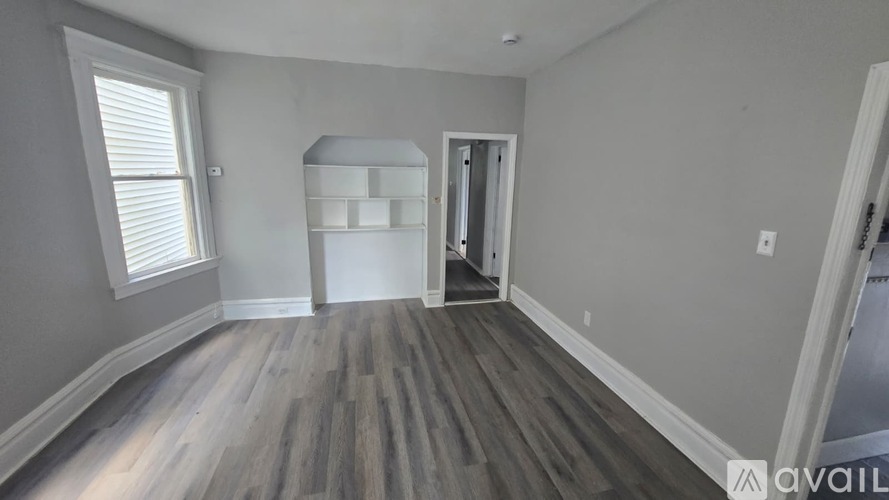 A room with wooden floors and a white door.