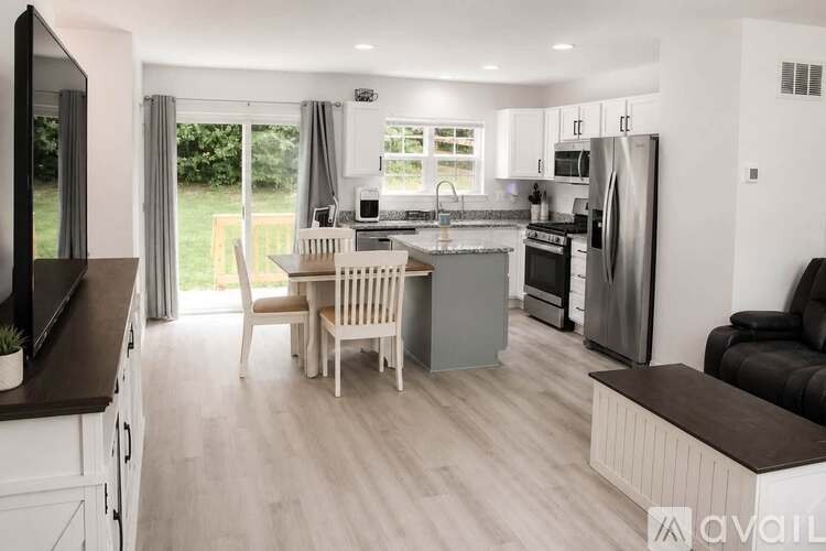 A modern kitchen with a dining table and chairs.