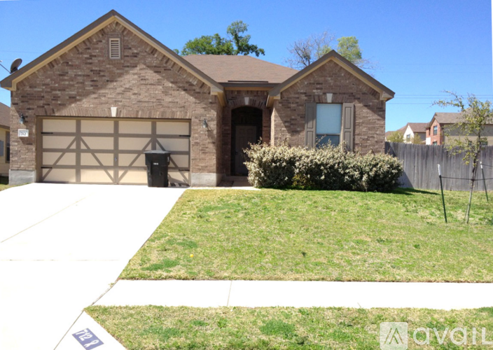 A house with a brown brick exterior and a white garage door.