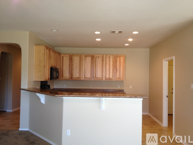 A kitchen with wooden cabinets and a white island.