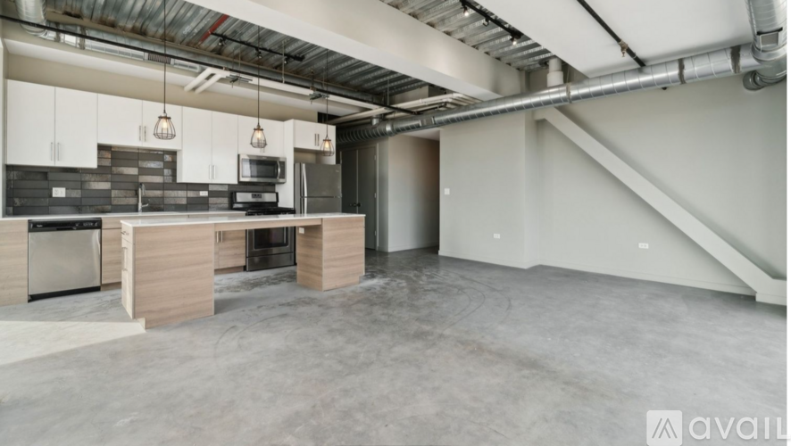 A spacious kitchen with a dining area and a staircase.