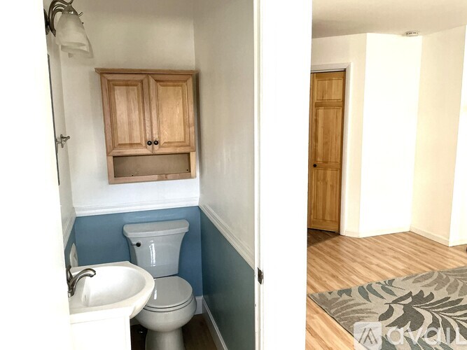 A bathroom with a toilet and sink.