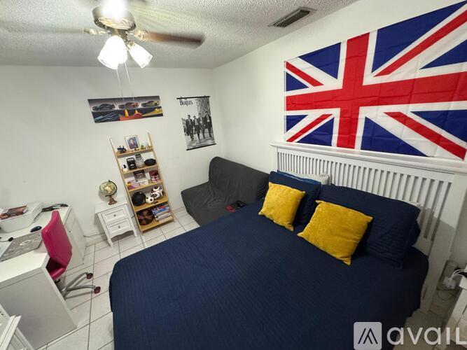 A bedroom with a large bed and a British flag on the wall.