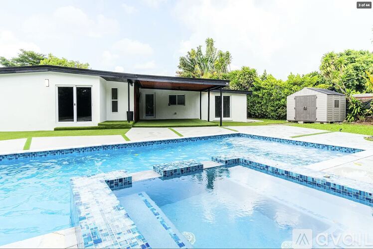A swimming pool in front of a house.