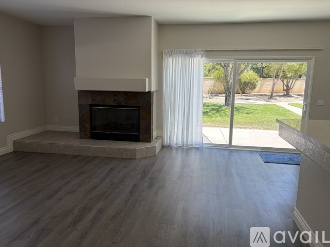 A living room with a fireplace and sliding glass doors.