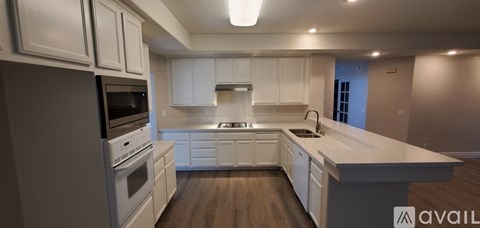 A kitchen with white cabinets and a large island.
